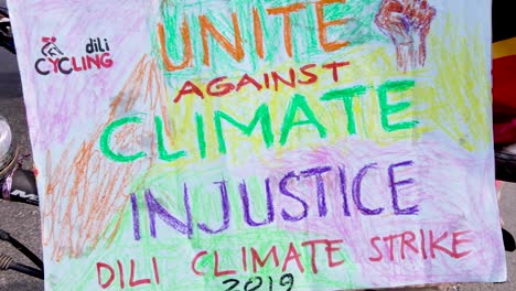 people gathering, marching and unite against climate injustice closeup. climate change march in capital dili, timor leste, southeast asia.
