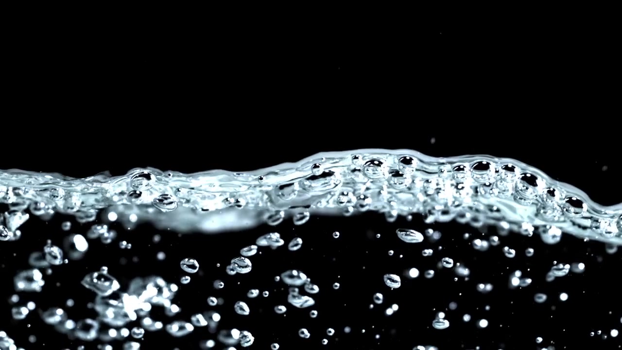 Clear Water Surface with Bubbles and Gentle Movement on Black Background