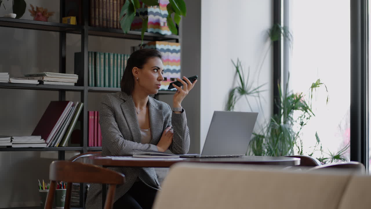 Woman holding smartphone device using voice recognition function recording audio message or talking with mobile assistant. Authentication communication online technology concept.