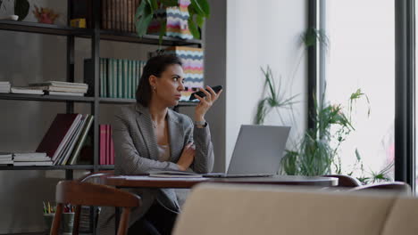woman holding smartphone device using voice recognition function recording audio message or talking with mobile assistant. authentication communication online technology concept.