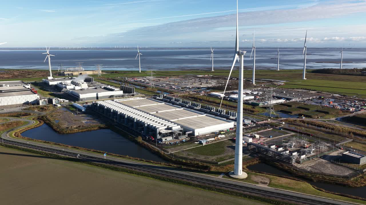 Aerial drone video showcasing the ongoing expansion of a large-scale, high-tech hyperscale data center in Eemshaven, Netherlands, a critical infrastructure hub for AI and computing power
