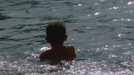 child swimming in the ocean