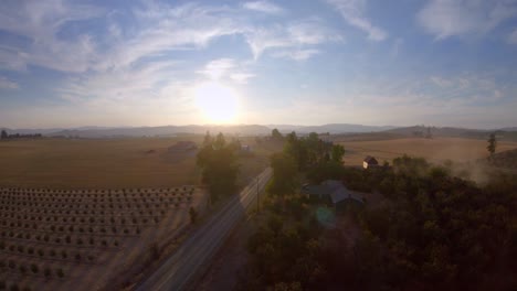 aerial push of farming countryside during sunset