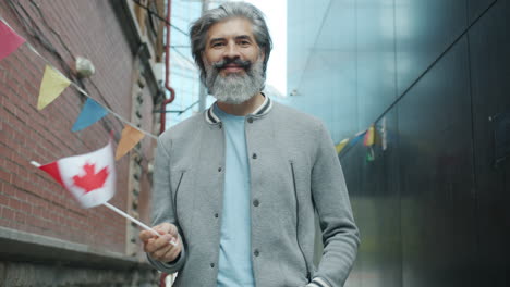 man with canadian flag in urban setting