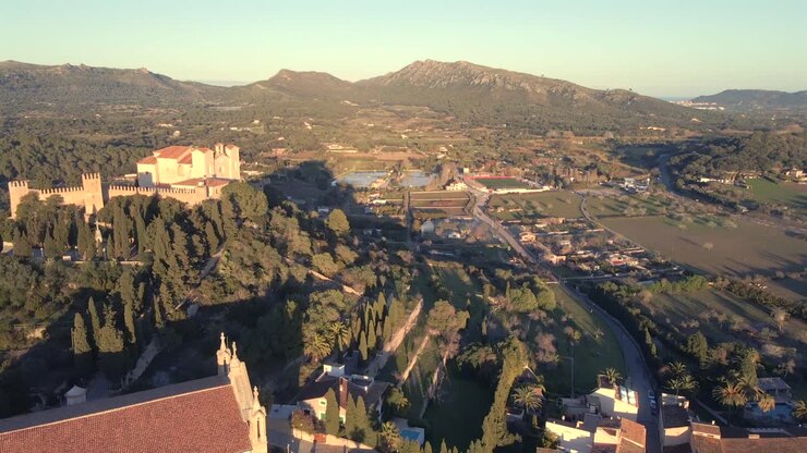 Discover the breathtaking views of Arta, Mallorca, showcasing the charming architecture and lush countryside bathed in warm golden light.