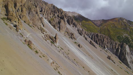 Muddy-stone-hills-at-Nepal-Annapurna-circuit,-landscape-drone-shot-unique-nature-rocks,-greenery-background,-mountain-adventure-4K