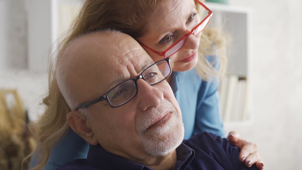 Old couple. They are happy and hugging.