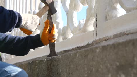 repairing a concrete wall adjacent to a white fence