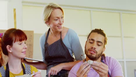 drawing teacher assisting artist in pottery 4k