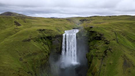 picturesque skogafoss waterfall landscape during gorgeous iceland summer, aerial drone establishing view