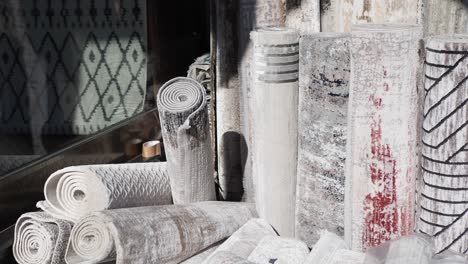 rolled up carpets and rugs in store display