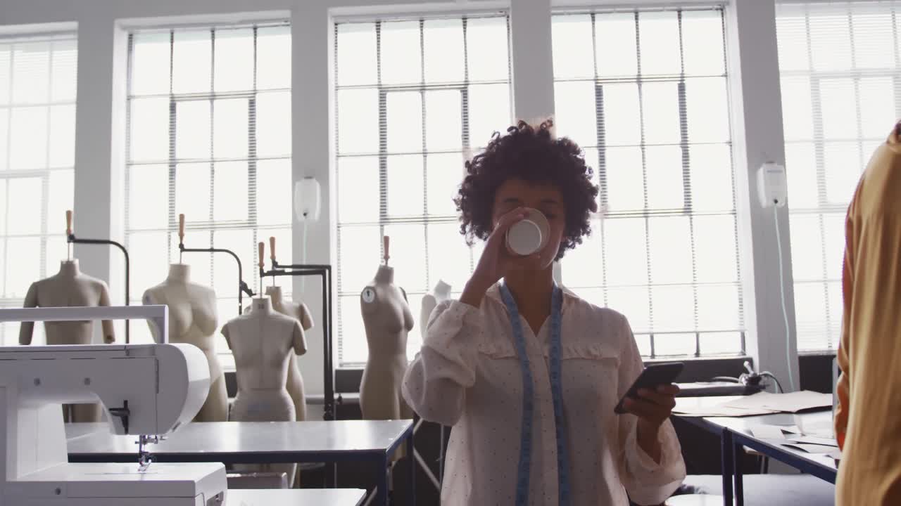 Mixed race woman working in fashion office