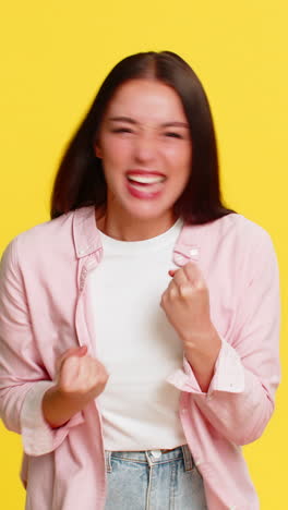 woman celebrating victory with joyful excited expression hands raised cheerful emotional happy mood