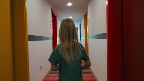 young girl walking down colorful corridor