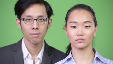 young happy asian business couple smiling together