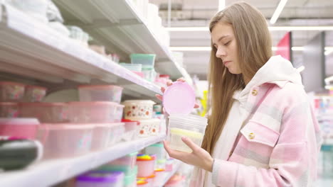 woman shopping for food containers in a supermarket