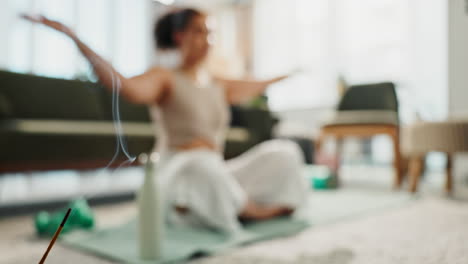 Woman meditating at home with incense