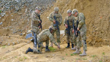 Vorderansicht-Von-Gemischtrassigen-Militärsoldaten,-Die-Während-Der-Militärischen-Ausbildung-Auf-Dem-Feld-Planen,-4k