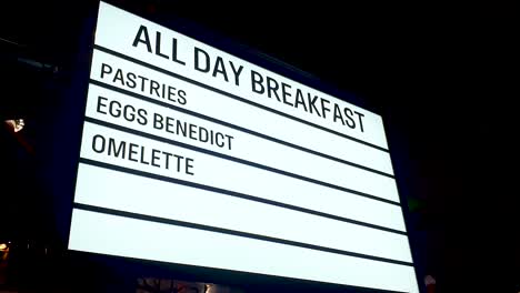 all day breakfast, pastries, eggs benedict and omelette neon led sign surrounded by flashing fairy lights at diner restaurant cafe