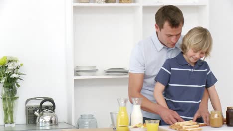 Panorama-of-dad-and-son-preparing-toasts-in-the-kitchen