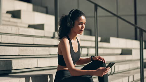 fitness, woman and headphones with phone on stairs