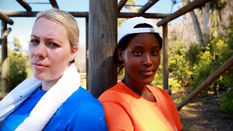 Portrait-of-determined-friends-standing-together-during-obstacle-course