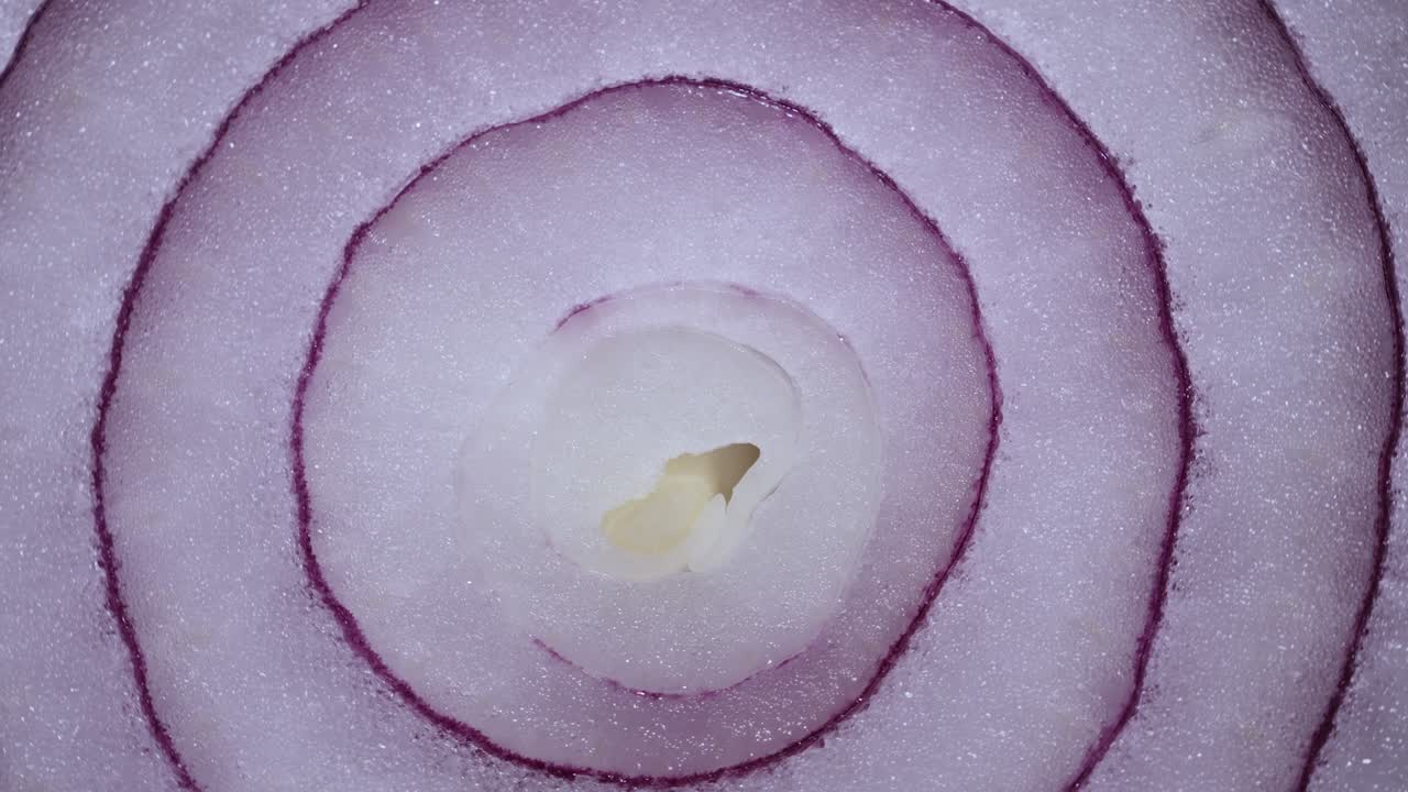 Texture Red Onion Rings Rotating, Close-up Top View. Harvested  Healthy Food Background With Vegetable Of Rich Vitamin. Sweet Red Spanish Onion Macro Shot. Food Background Closeup Sliced Purple Onion