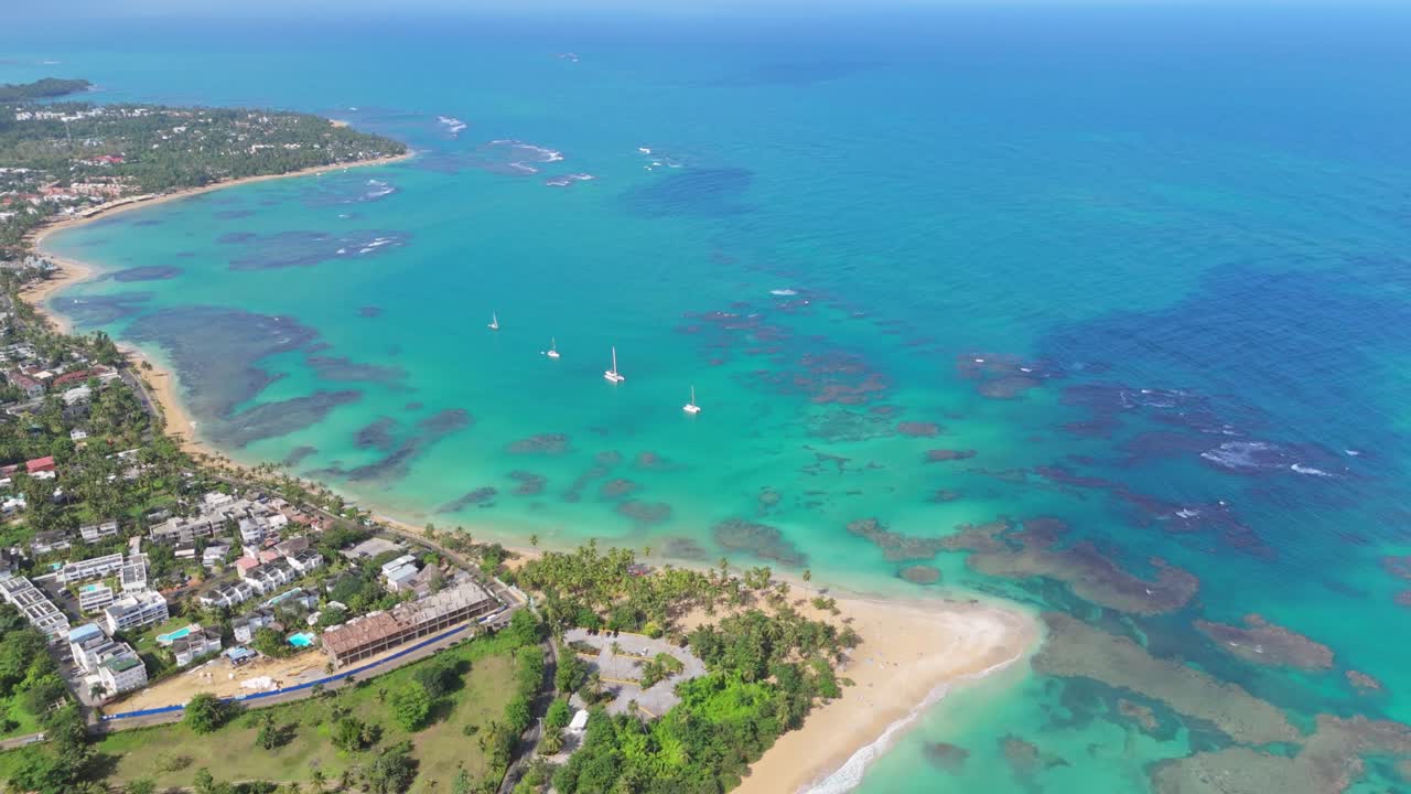 Aerial shot of Punta Popy Beach, Las Terrenas, showcasing the stunning view of the coastline, crystal-clear sea, and the tropical landscape in all its glory
