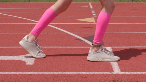 young teen girl athlete is set and ready to go on the track