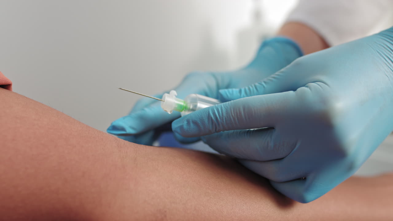 Laboratory worker doctor takes a blood sample for analysis hand closeup blood sampling in the