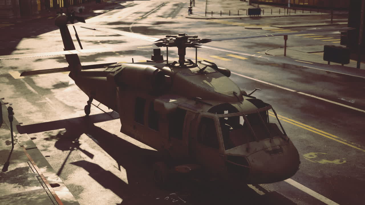 Military helicopter parked on a deserted urban street at sunset