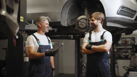 car mechanics discussing repair