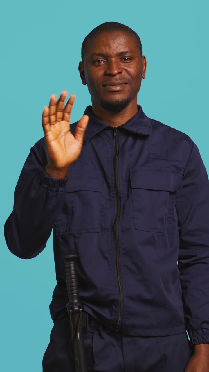 African American Security Guard Making Stop Gesture and Smiling