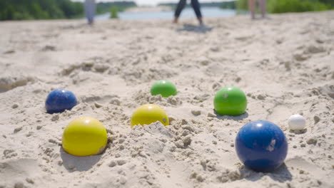 Close-up-view-of-some-colorful-petanque-balls-on-the-beach-on-a-sunny-day