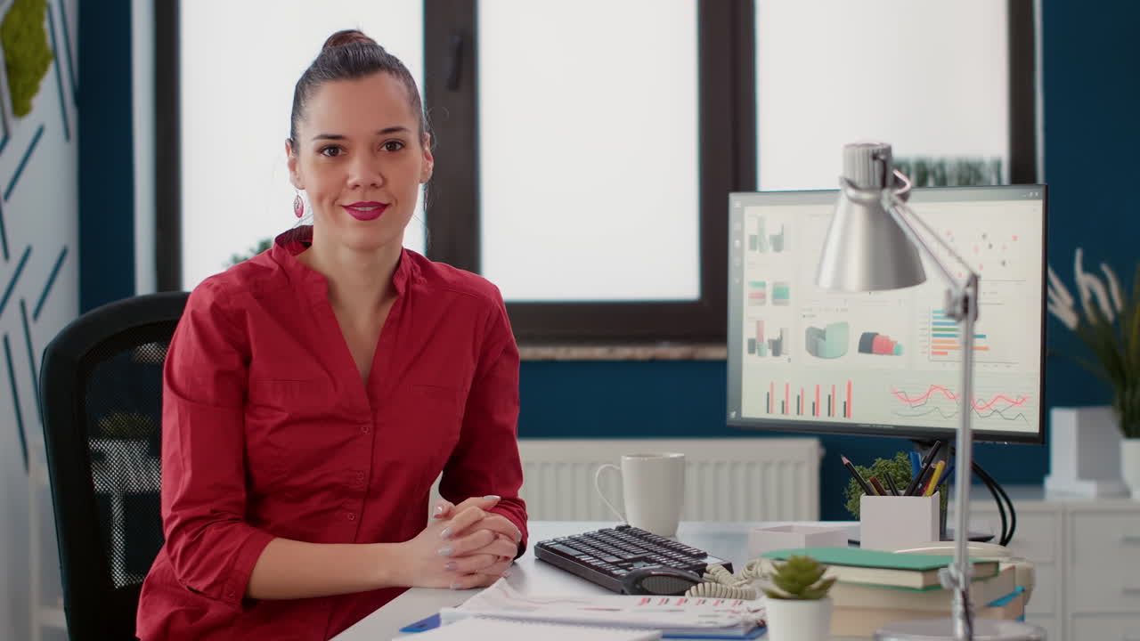 Portrait of project manager sitting at office desk to work on business