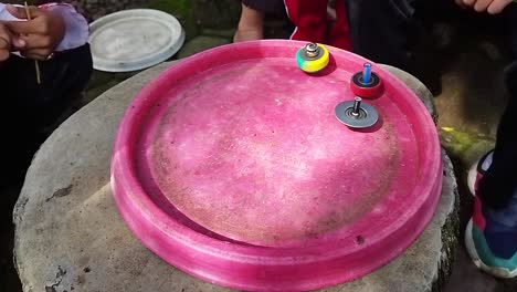 colorful gasing or spinning top is dolanan bocah, returns the old game or traditional game at the car free day event