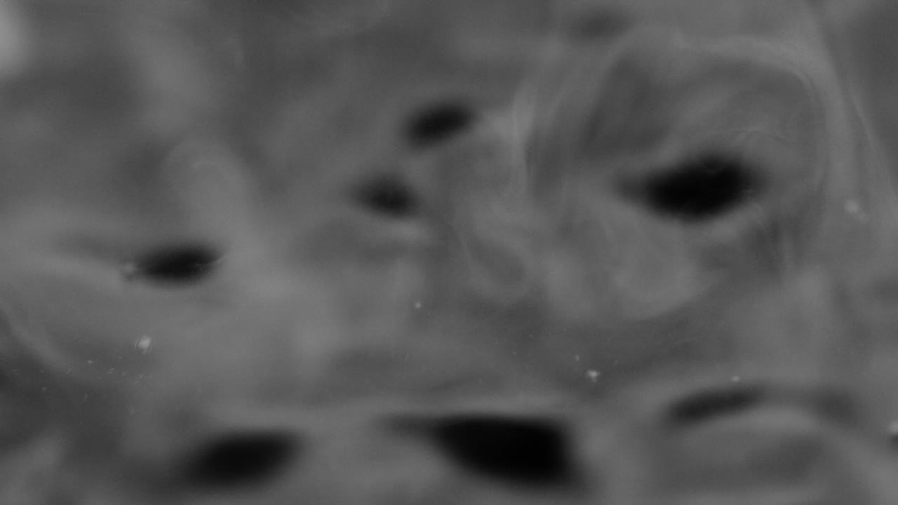 Splashes and drops on the surface of the liquid. Abstract Black Background Water vibration. 4K slow motion 100 fps, ProRes 422, 10 bit