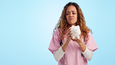 Nurse-woman,-piggy-bank-and-thumbs-down-in-studio