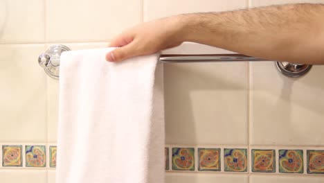 closeup shot of housekeeper placing clean bath towels in the bathroom 2