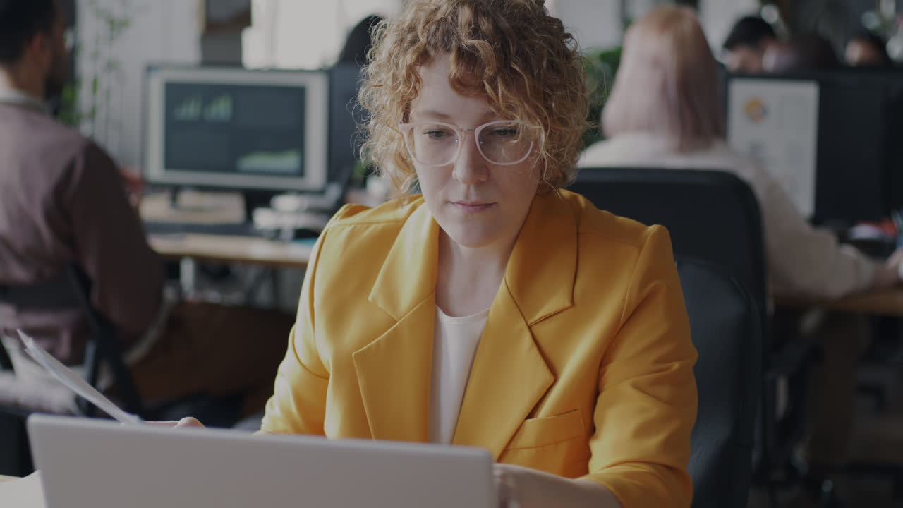Woman reviewing documents in an office setting