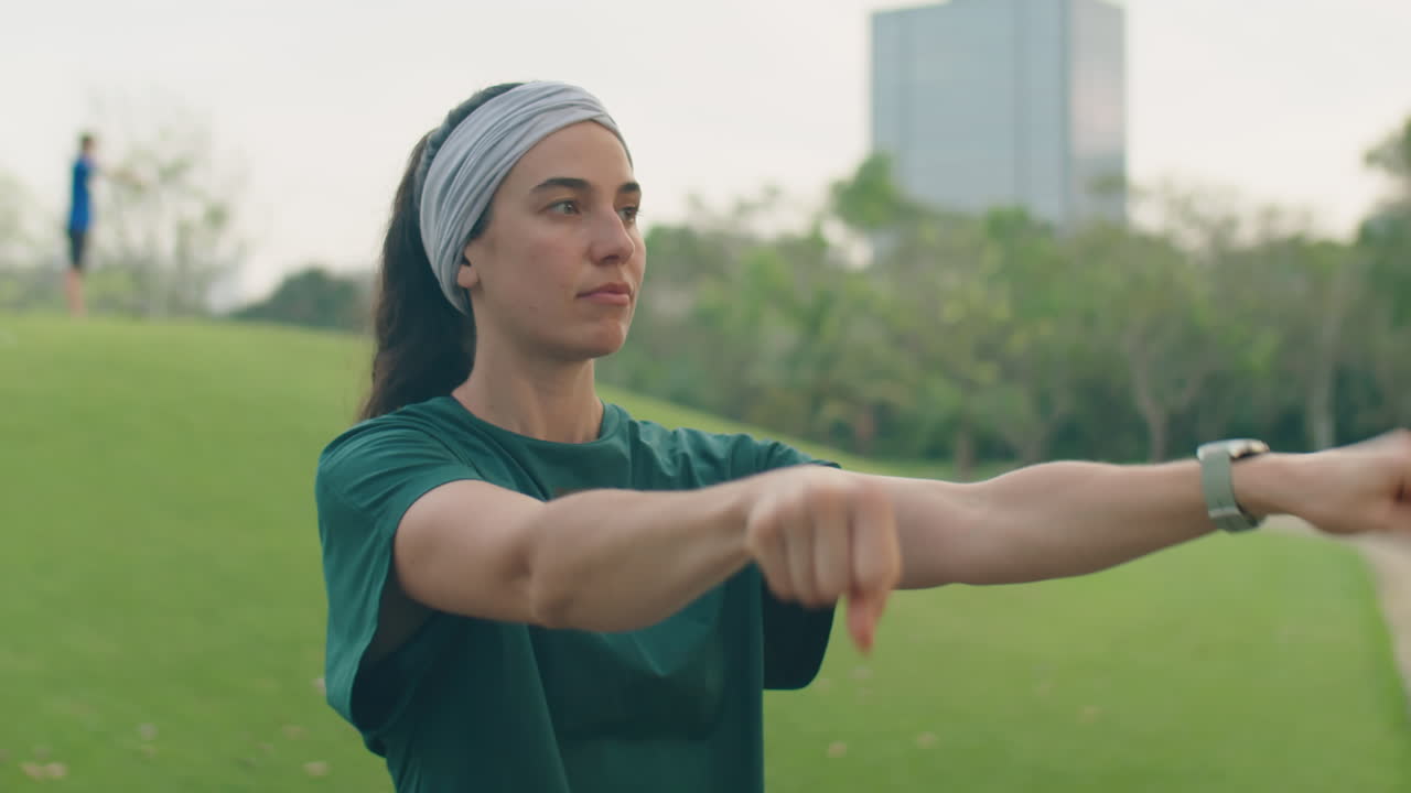 Woman Warming Up before Training in Park