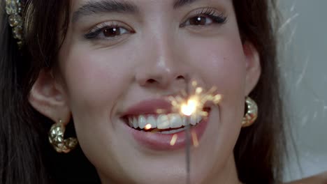 woman appears delighted with sparkler of fire bringing light into her life