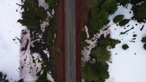 top down view of oregon mountain pass highway, white car traveling through