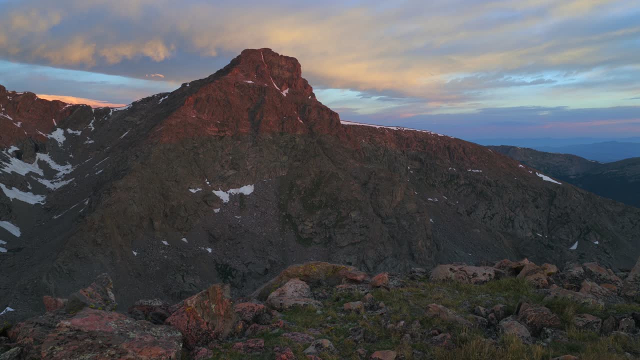 Sunrise magical first light early morning Mount of the Holy Cross 14er peak wilderness aerial drone Colorado summer clouds Rocky Mountains Halo Ridge Notch Mountain Sawatch Range pan left motion