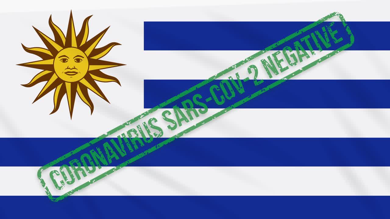 우루과이가 코로나 바이러스로부터의 자유의 녹색 스프를 가진 발을 흔들고 있습니다.