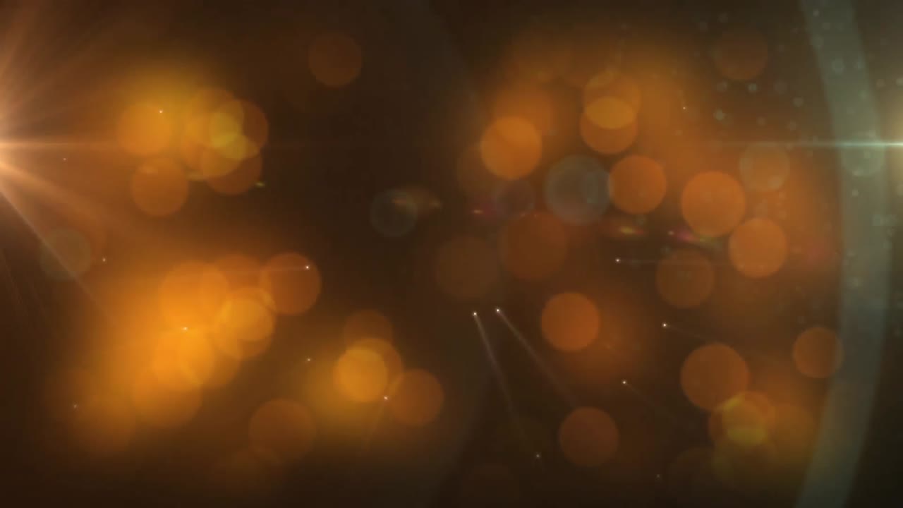 manchas brillantes naranjas y manchas de luz contra un fondo negro