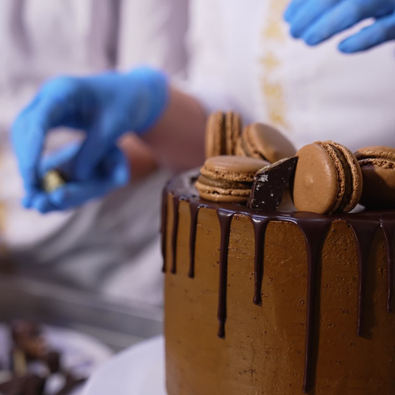 Chocolate macaroons cookies are put on top of the cake. Candies are laid among the biscuits. Close up