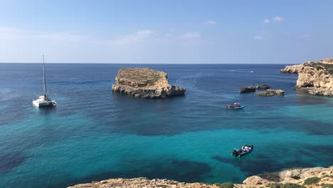 luxury-yacht-moored-in-comino-island-Mediterranean-Sea-during-sunny-day-of-summer