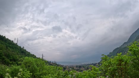path along bolzano lungotalvera with overviews of hills, trees, and riverbanks under cloudy sky