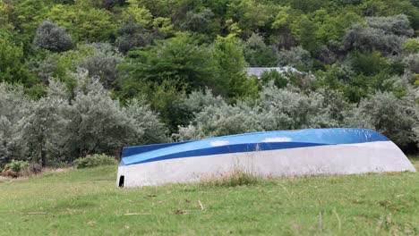 Wooden-Dinghy-Boat-Flipped-Over-Grassy-Ground